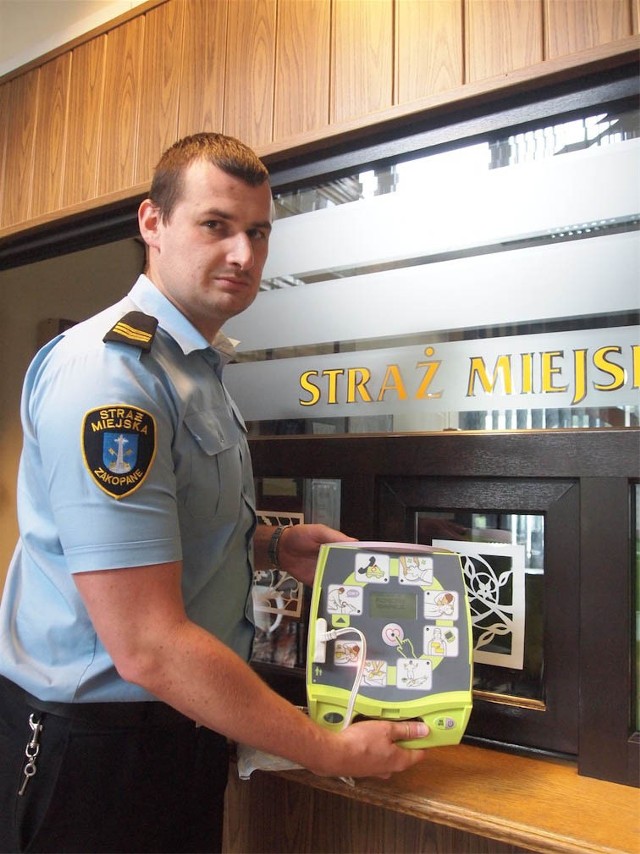 Strażnik miejski Rafał Filas prezetuje defibrylator, który znajduje się w Urzędzie Miasta.  - Wiemy, jak go używać. Na szczęście nie musieliśmy jeszcze tego robić - mówi
