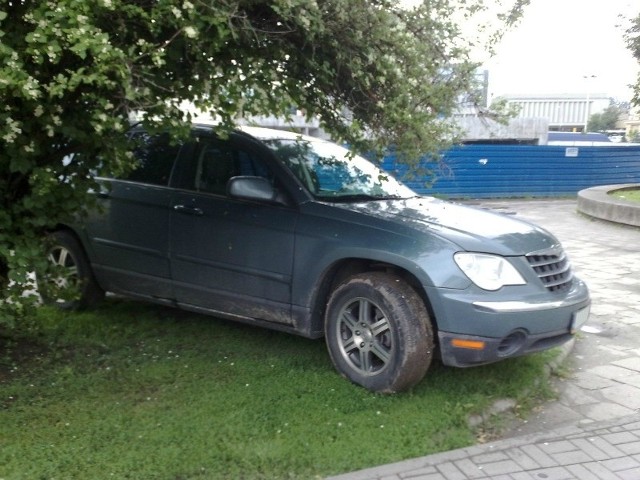 Chrysler na trawniku w centrum Rzeszowa.
