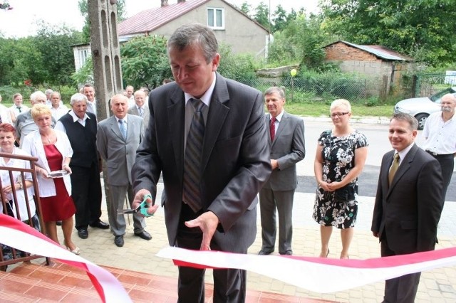 Wójt Krzysztof Michalec przecina wstęgę przy wejściu do nowego ośrodka