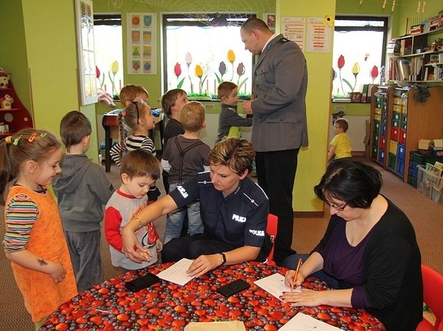 Pamiątką ze spotkania są dla dzieci odciski palców, odbite na kartkach papieru przez policjantów.