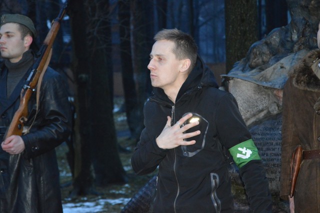 Ksiądz Jacek Międlar podczas niedzielnego spotkania pod pomnikiem „Ognia”. Miał na rękawie symbol „falangi”.