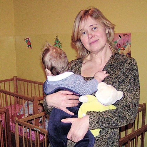 Jedna z dziewczynek w bezpiecznych ramionach Elżbiety Kowalczyk z domu opieki nad dziećmi w Lęborku.