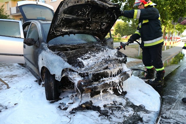 Przy rondzie imienia księdza Warchoła strażacy gasili płonącego opla austrę przy pomocy piany, pojazd spłonął