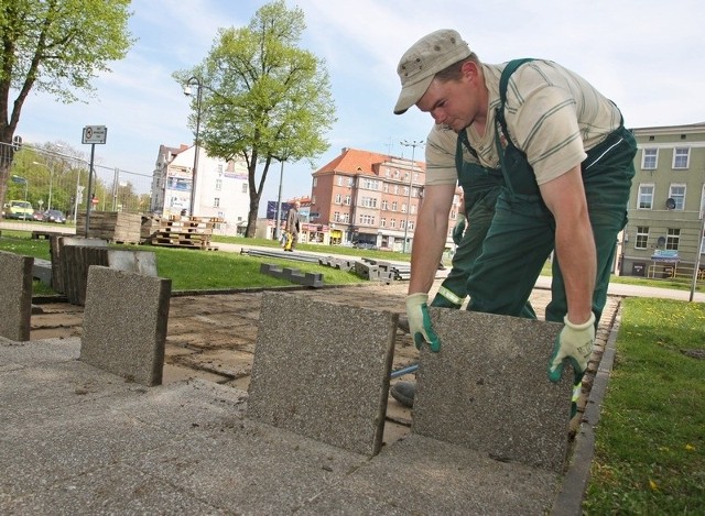 Pracownik firmy Sanimet demontuje chodnik w parku przy al. Sienkiewicza. 