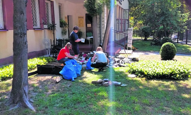 Pracownicy biblioteki segregują zniszczone książki.