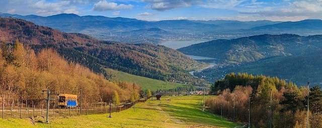 GÓRA ŻARGóra Żar w Beskidzie Małym to popularny wśród turystów szczyt o wysokości 761 m n.p.m. nad Jeziorem Międzybrodzkim. Na sztucznie spłaszczonym wierzchołku góry jest zbiornik wodny będący częścią kompleksu elektrowni szczytowo-pompowej. Na Górę Żar można wjechać szybko i wygodnie koleją linowo-terenową. Przewozi ona 1200 osób na godzinę.