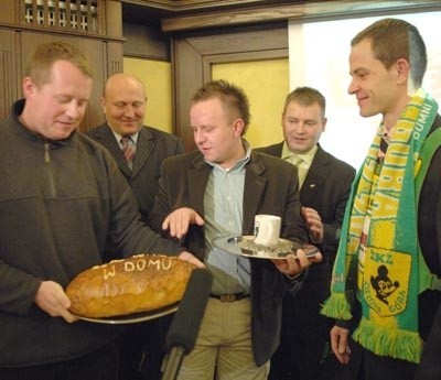 Marcin "Fazi&#8221; Grygier (z lewej) i Maciej "Jabol&#8221; Jabłoński z klubu kibica Falubaz Net F@ns przywitali Piotra Protasiewicza chlebem i żużlem. Na bochenku był napis "PePe, witaj w domu&#8221;.