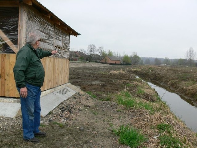 Eugeniusz Durda, radny Suchorzowa, pokazuje miejsce, gdzie będzie znajdował się zalew wraz z pomostem.