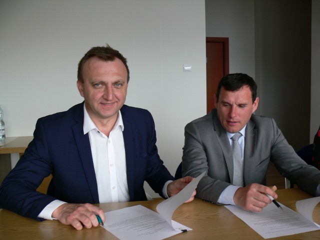 Od lewej :Starosta Marcin Piwnik i wójt Klimontowa Marek Goździewski podpisują ostatnie dokumenty związane z przekazaniem liceum.