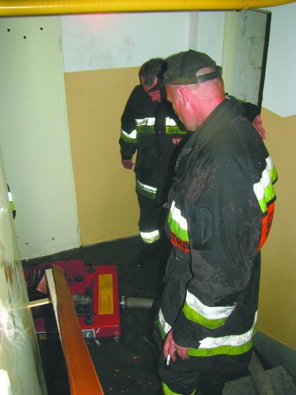 Strażacy wypompowują wodę z piwnicy jednego z bloków przy ul. Kościelnej w Wasilkowie