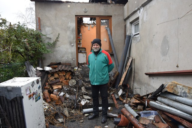 Jacek Kowalski na tle ruin swego domostwa
