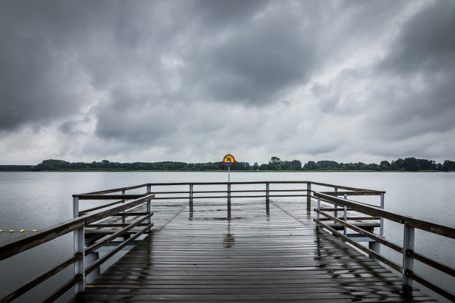 Plaże w regionie puste. Deszcz pada i na razie nie zapowiada się, by weekend przyniósł pogodę, która sprzyjałaby wylegiwaniu się na piasku w promieniach letniego słońca... Do końca lipca możemy nie liczyć na słoneczną pogodę. Pochmurne będą też pierwsze dni sierpnia. Nasze województwo pozostaje w obszarze niżów. W większości dni nad region będzie napływać wilgotne i umiarkowanie ciepłe powietrze. Do końca miesiąca można także spodziewać się silnych i gwałtownych burz. Na Kujawach i Pomorzu mocniej zagrzmi najprawdopodobniej jeszcze dziś (28 lipca) oraz w sobotę. Niedziela z większymi przejaśnieniami - to może być najładniejszy dzień w najbliższym czasie, ponieważ od poniedziałku zapowiadane są wysokie temperatury (31-34 stopnie) ale jednocześnie silne burze.Czy plaże będą świeciły pustkami jak ta w Chmielnikach? Na słoneczną i suchą aurę trzeba będzie jeszcze trochę poczekać...Co zatem robić w Kujawsko-Pomorskiem? Zobaczcie, co się będzie działo: