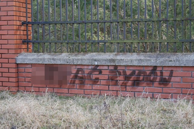 Wulgarne napisy na ogrodzeniu cmentarza żydowskiego w Kozienicach.