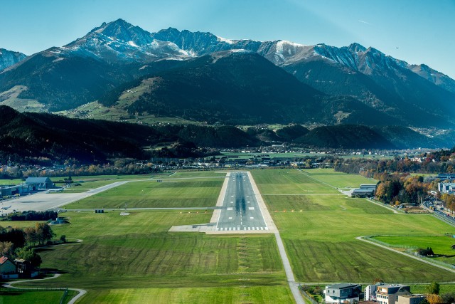 By wylądować w stolicy Tyrolu pośród malowniczych Alp, należy najpierw pokonać niesprzyjający wicher i nie rozbić się o pobliskie szczyty, osiągające nawet 2500 m n.p.m. Samoloty muszą wykonywać trudne skręty, by zejść na pas, za to turyści mogą oglądać z okien zapierające dech w piersiach widoki. Mówi się, że lądowanie w Innsbrucku przypomina wlatywanie do paszczy wielkiego potwora, którego zębami są góry, a językiem wąska dolina daleko w dole.