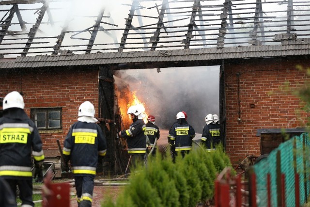 Strażacy gaszą pożar, jaki wywołało uderzednie pioruna, a potem rozebrali zwęglone drewniane elementy dachu