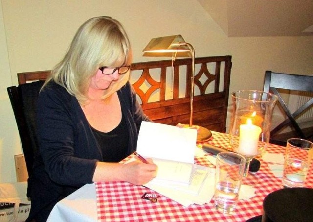 Dorota Ryst podpisuje swój tomik poezji.