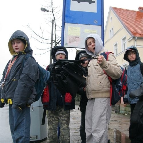 Uczniowie Szkoły Podstawowej nr 1 w Ustce w strugach deszczu muszą czekać na autobus do szkoły.