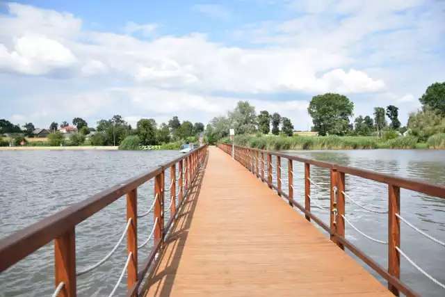 Strefa rekreacji nad stawem w Januszowicach z plażą, molo, placem zabaw i pięknymi widokami