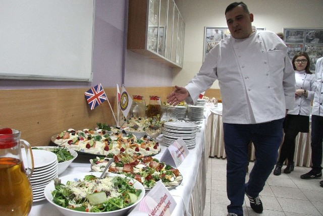 Szef kuchni Hubert Sanecki prezentuje przystawki, które kucharze wykonali wraz z uczniami.