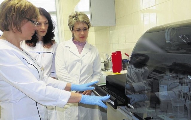 Dr Iwona Ponurkiewicz, kierownik hajnowskiego laboratorium, prezentuje laborantom z Grodna zautomatyzowany system wykonywania testów   