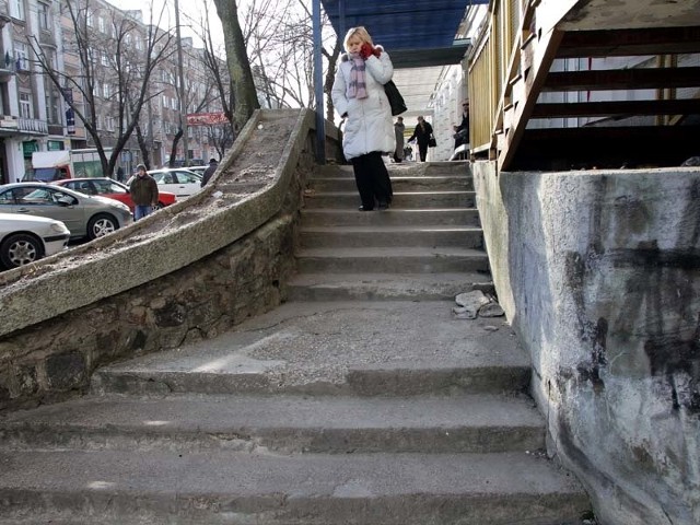 Schody, po których ludzie wchodzą do sklepów w budynku przy ulicy Sienkiewicza 9 są w opłakanym stanie. Po zimie beton pokruszył się. Schody trzeba natychmiast wyremontować.