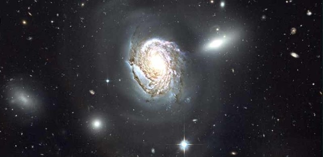 NGC 4911: Spiral Diving into a Dense Cluster