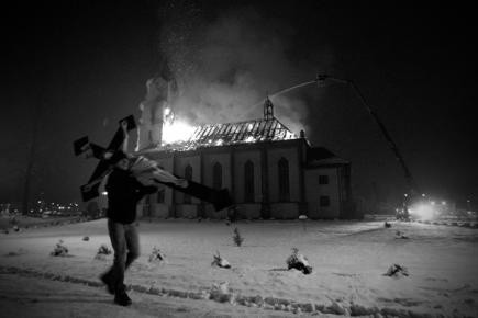 ZDJĘCIE ROKU 2013: Michał Legierski, Agencja Fotograficzna EdytorMężczyzna wynosi krzyż z płonącego kościoła w Orzeszu-Jaśkowicach. Pożar wybuchł w nocy, gasiło go 30 sekcji straży pożarnej. Gdy tylko zauważono ogień, pod kościół zbiegło się wielu mieszkańców. Z kościoła wynoszono wszystko, co dało się uratować, rozebrano nawet częściowo organy, by je ocalić. Pomoc w odbudowaniu spalonej części świątyni zaoferowali wierni i okoliczne parafie. 14 stycznia 2013