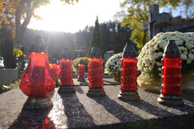 Cmentarz parafialny w Gdyni i jeden z grobów, który ozdabiają kwiaty i znicze na Wszystkich Świętych