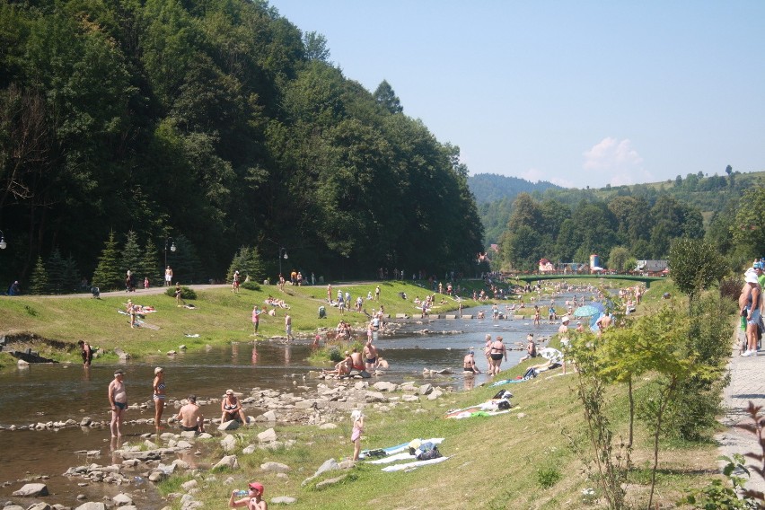 Turyści i kuracjusze spędzają upalne dni nad potokiem...