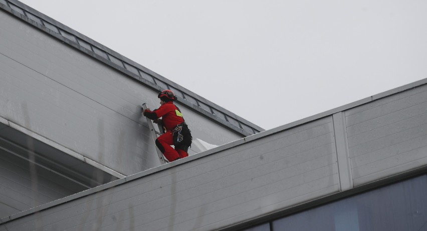 Strażacy zabezpieczają zerwane po wichurze pokrycie dachowe...