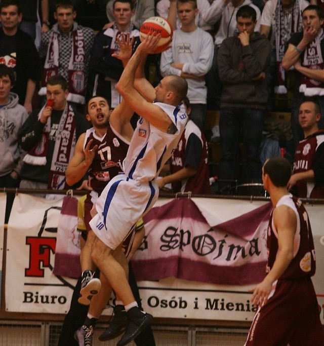 Koszykarz AZS Łukasz Biela (z piłką) składa się do rzutu, będąc ściśle pilnowanym przez Huberta Mazura. Skrzydłowy gospodarzy rzucił Spójni 15 punktów.
