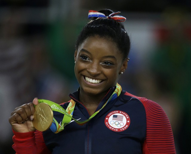 Zawodniczka reprezentująca Stany Zjednoczone, Simone Biles trzymająca swój złoty medal zdobyty w kategorii gimnastyka sportowa kobiet podczas Igrzysk Olimpijskich w Rio de Janeiro 2016
