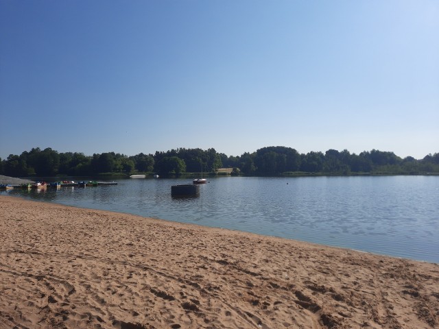 W sobotę odbędzie się inauguracja sezonu letniego w ośrodku nad Stawem Górnym w Pionkach. Choć sam zbiornik nie jest duży, obiekty, urządzenia i panująca wszędzie czystość stawiają ten ośrodek chyba najwyżej na liście wszystkich miejsc nad wodą w regionie radomskim, gdzie można spędzić czas podczas upalnych dni. Są tam atrakcyjne place zabaw dla dzieci, boiska, tężnia solankowa, wypożyczalnia kajaków i łódek, jest punkt gastronomiczny, przebieralnia, natryski. Wszędzie bije w oczy czystość i porządek. Są eleganckie ławki, stoliki, leżaki, kosze na śmieci, czysty piasek na plaży. Jest też punkt gastronomiczny. Dokonano nasadzeń drzew, krzewów. Do ośrodka prowadzi szeroka ścieżka rowerowa, a do tego w niedalekiej odległości jest obszerny parking przy przebudowanej niedawno drodze. Na kolejnych slajdach sami zobaczcie jak wygląda teraz ośrodek nad Stawem Górnym >>>