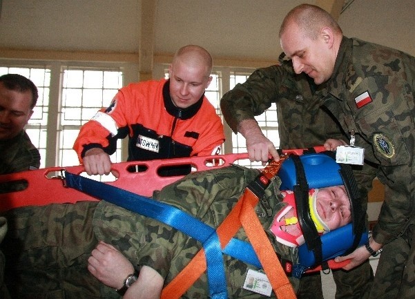 Wszyscy kursanci przeszli szkolenie w zakresie usztywniania złamanego kręgosłupa i ewakuacji rannego na desce ortopedycznej. Jak zaznaczał ratownik Mariusz Palacz (w środku), prawidłowo przywiązaną do niej osobę można nieść nawet bokiem. 