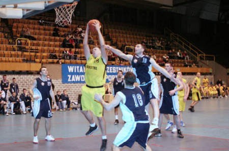 Tomasz Gembus (drugi z lewej) walczy pod tablicą z koszykarzami AZS Opole.