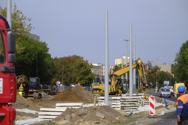 Remont placu Chrapka i okolic trwa. To nie tylko utrudnienia dla kierowców. Widać też kolejne postępy w pracach. Budowa torowiska, roboty kanalizacyjne, asfaltowanie jezdni - tak obecnie wygląda plac budowy. Dobra pogoda pozwala na intensywne realizowanie robót.

Zobacz także: Wypadek na Szosie Lubickiej. Trzy osoby w szpitalu. Kierowca chciał uciec!

Największe siły skupione są na przebudowie torowiska. Obecnie wykonawca układa w tym miejscu nawierzchnię betonową. - W kolejnym etapie  będziemy montować  i spawać szyny.  W ramach zadania na odcinku 420 metrów ułożymy 1600 metrów szyn - wylicza Daniel Kurowski, kierownik budowy z ramienia firmy Skanska S.A. 

Zobacz także: Kolejny niewybuch w regionie! Ewakuowano 400 osób!
Równolegle przy ulicy Przy Kaszowniku (na jezdni w stronę ronda Pokoju Toruńskiego) wykonywana jest konstrukcja nowej jezdni wraz z kamiennymi krawężnikami i zatoką autobusową. Z kolei na ulicy Warneńczyka budowany jest kolektor deszczowy, który odwodni przebudowywaną ulicę.  Prace te są prowadzone na głębokości od 5 do 9 metrów. Na budowie pracują także elektrycy, którzy układają kable pod przyszłe oświetlenie ulic.

Zobacz także: Weekend w Toruniu. Tak się bawił Toruń w Bajka Disco Club. Imprezy "Tyle Słońca w Całym Mieście" za nami [ZDJĘCIA]

W najbliższych dniach wykonawca planuje wprowadzenie kolejnego etapu organizacji ruchu. Do ruchu zostanie udostępniona nowo wybudowana jezdnia ulicy Przy Kaszowniku (od strony stawu).

Inwestycja zakończy się w marcu 2019 roku i jest realizowana z unijnym dofinansowaniem.

Przebudowa placu Chrapka. Nowe tory, asfalt i głębokie wykopy [ZDJĘCIA]