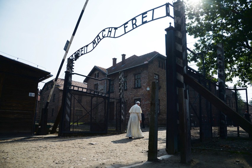 Pope francis walks through the gate of the former nazi...