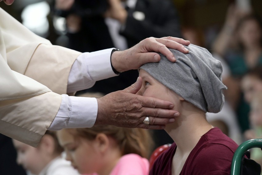 Pope francis blesses a child during his visit to the...