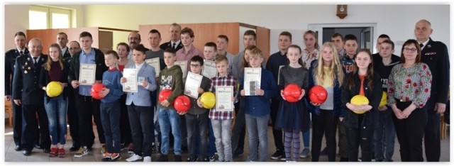 Uczestnicy powiatowego turnieju Ogólnopolskiego Konkursu Wiedzy Pożarniczej w Niedźwiedziu z dyplomami i nagrodami
