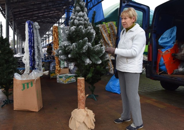 Teresa Wiater ogląda sztuczną choinkę na  wysokim stojaku