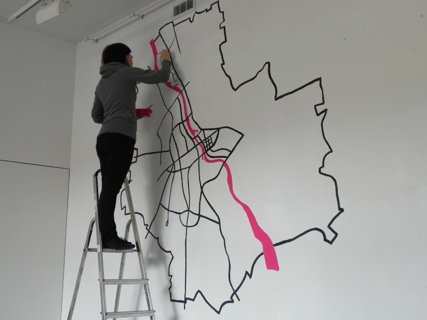 Artystka Ania Barlik maluje na ścianie mapę Warszawy. Przez...
