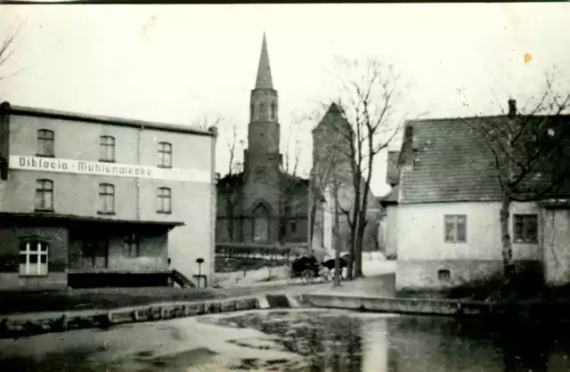 To zdjęcie zostało wykonane ok. 1905 roku. 

Widzimy na nim Staw Młyński w Pucku, do którego wpada rzeka Wałeczka. 

Właścicielami widocznego na zdjęciu młyna -  napędzanego parą wodną - byli Viktoria Mühle i Julius Priebe. 

 Najciekawszym elementem zdjęcia jest kościół ewangelicki, który został wzniesiony na fundamentach dawnej "warowni/ zamku" w roku 1845, natomiast  grunt został przekazany przez władze pruskie gminie ewangelickiej  w 1777 r. 

Na zdjęciu widzimy również dorożkę. Do kościoła ewangelickiego w Pucku przyjeżdżali swoją karocą co niedzielę np. właściciele majątku w Rzucewie rodzina von Below. 