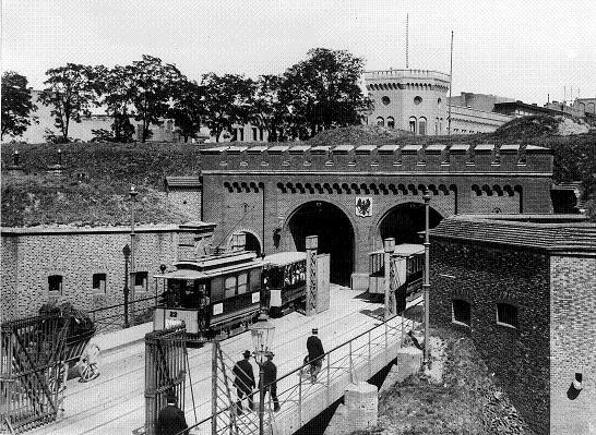 Rok 1901

Okno na zachód - miasta w murach. Zlikwidowana została w 1902 roku. Przez lata jeździły tędy tramwaje i wędrowali piesi. Było wiele wypadków. Brama była usytuowana w miejscu dzisiejszej ulicy Kościuszki. Prezentowany widok, to spojrzenie od strony kaponiery. Widoczny w głebi budynek został zburzony po wojnie i na jego miejscu postawiono budynek ówczesnego Komitetu Wojewódzkiego partii. Ostatecznie znalazł się on w rękach uniwersytetu - wydziału historii



Święty Marcin na archiwalnych zdjęciach - zobacz jeszcze więcej