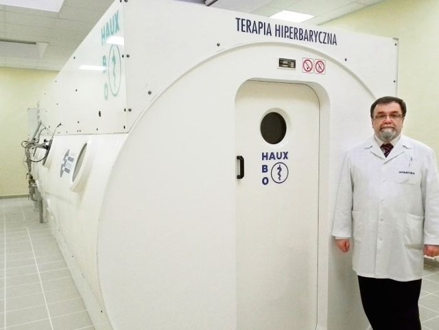Lek. med. Lesław Lenartowicz, prezes szpitala HCP demonstruje komorę hiperbaryczną w