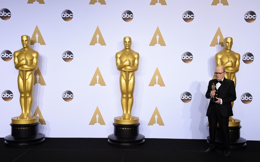 Ennio morricone poses in the press room with the award for...