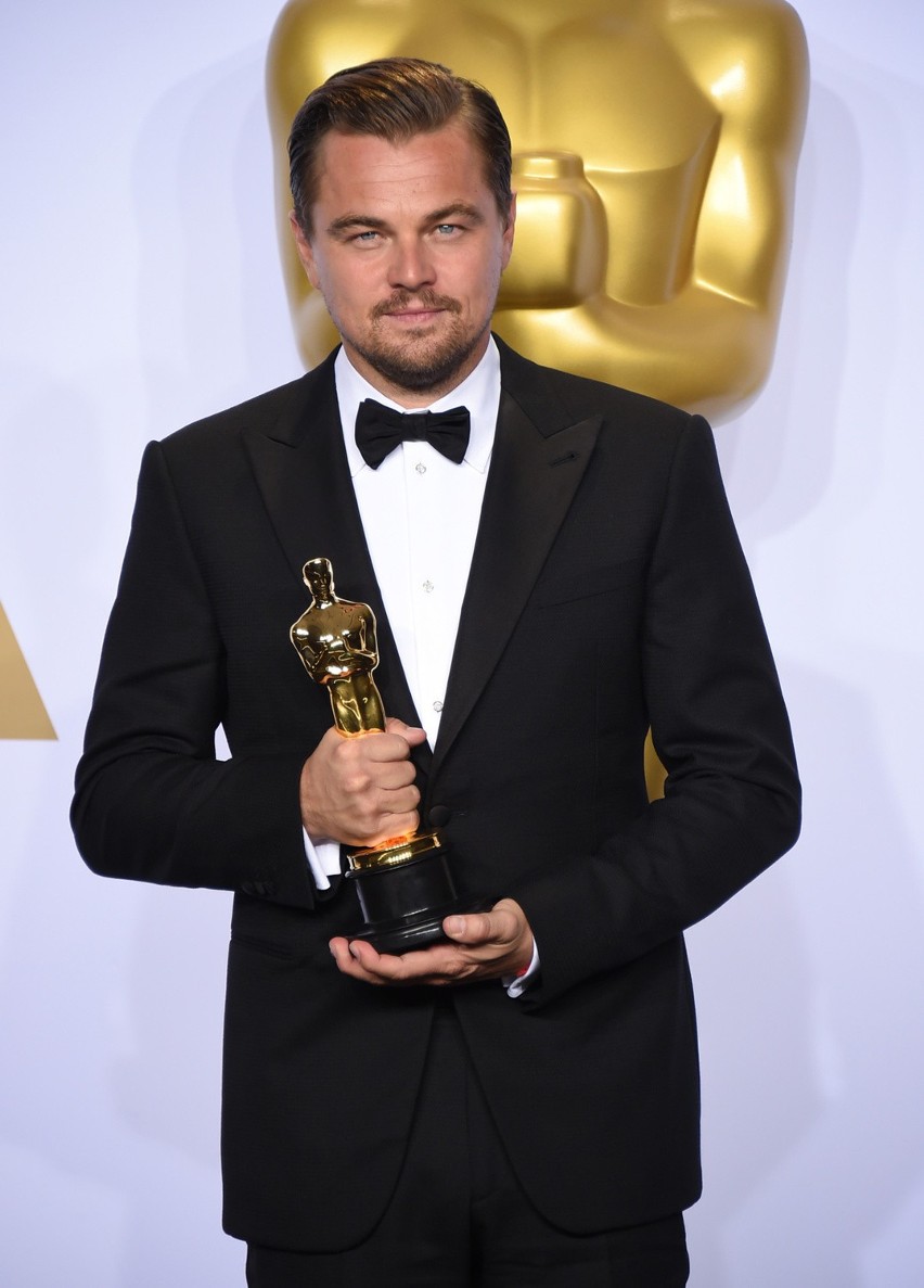 Leonardo dicaprio poses in the press room with the award for...