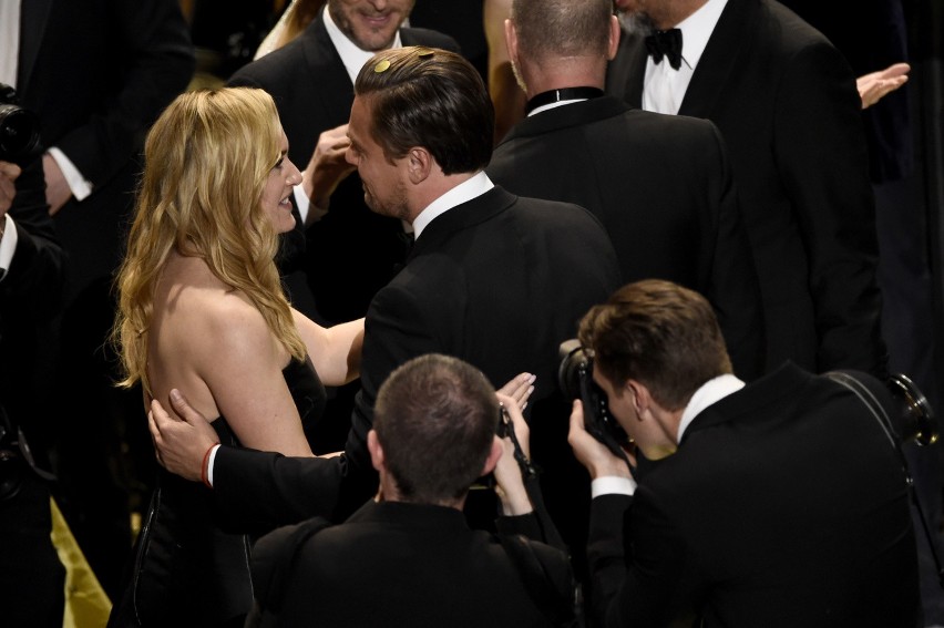 Kate winslet, left, congratulates leonardo dicaprio on stage...