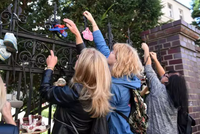 Protest przeciwko ukrywaniu przestępstw pedofilii - wieszanie dziecięcych bucików na płocie kurii w Poznaniu.