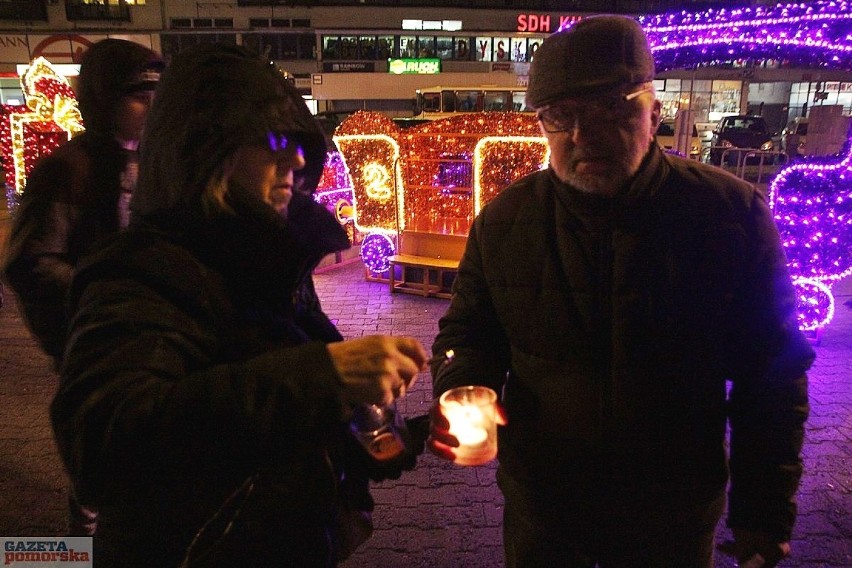 W rękach protestujący mieli zapalone lampki oraz kartki z...