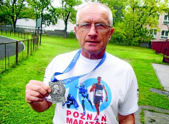 Józef Gręda z pamiątkową koszulką oraz medalem Maratonu Poznań